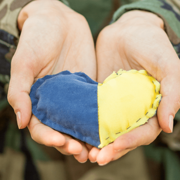 Ukraine blue and yellow heart in a set of open hands
