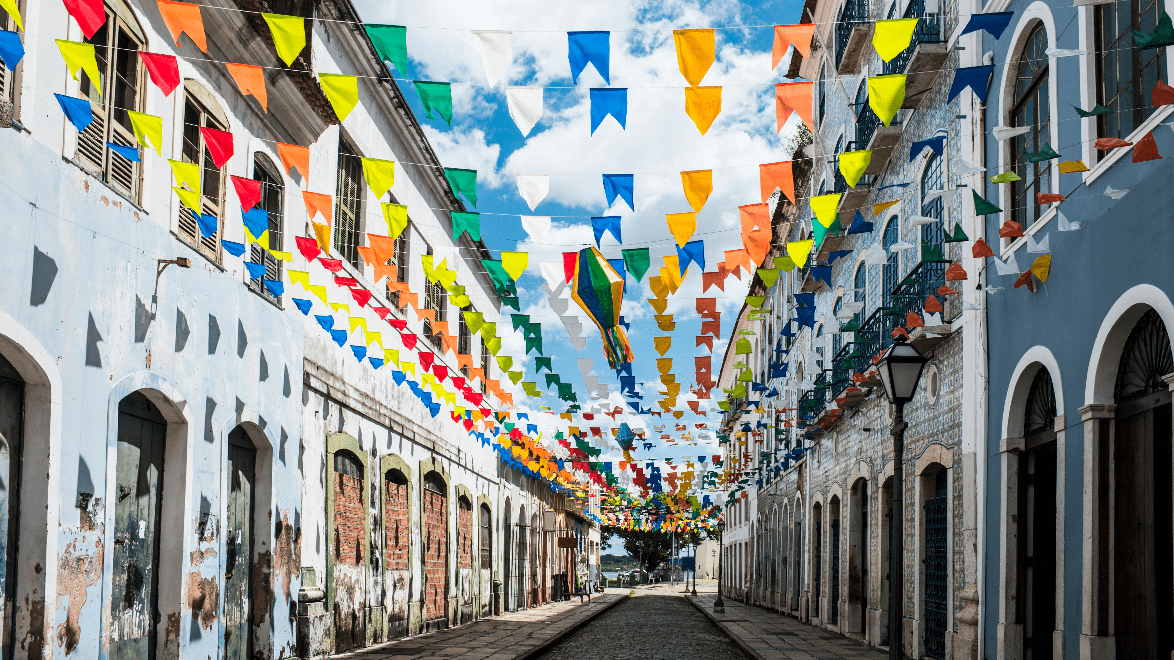 Brazil city with colored flags stretched over walkway