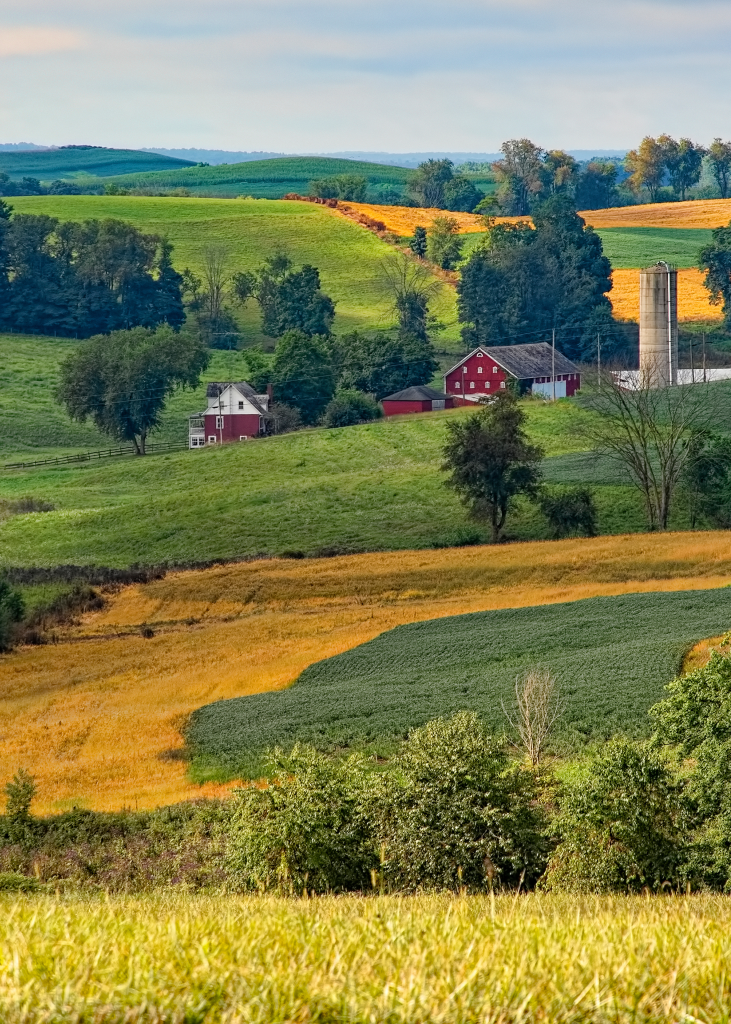 farm with red buildings on rolling hills of ohio