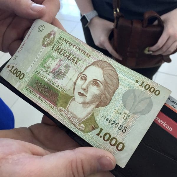 close up look of money in uruguay with a woman’s face on a 1000 bill