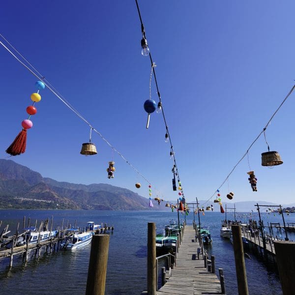 port with boat and toys hung on strings over dock