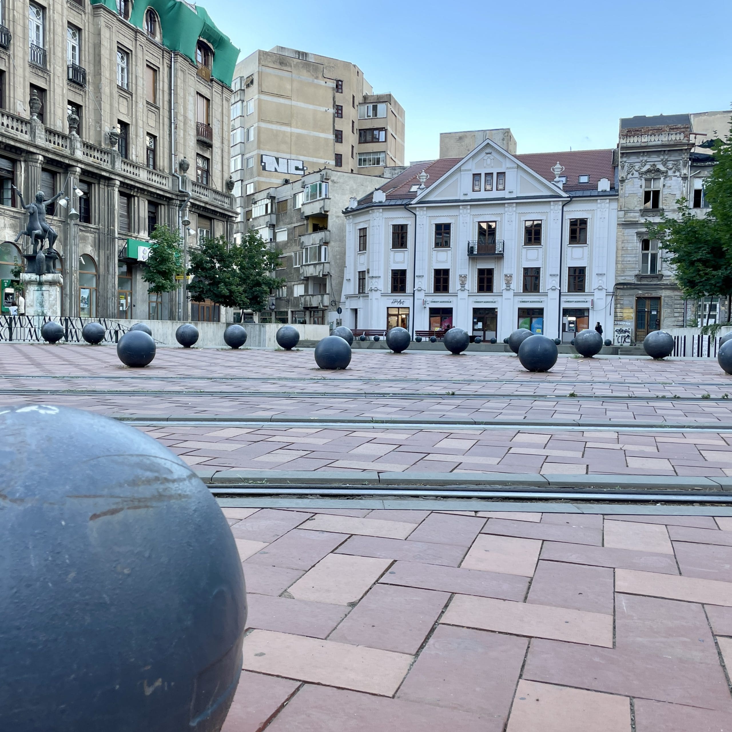 square with round balls scattered around pavers