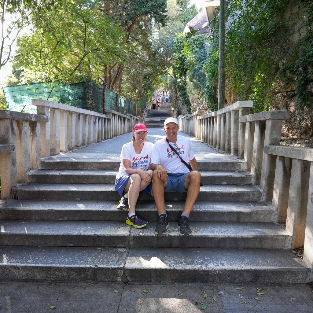 bev and john sitting on steps to top of Marjan Hill