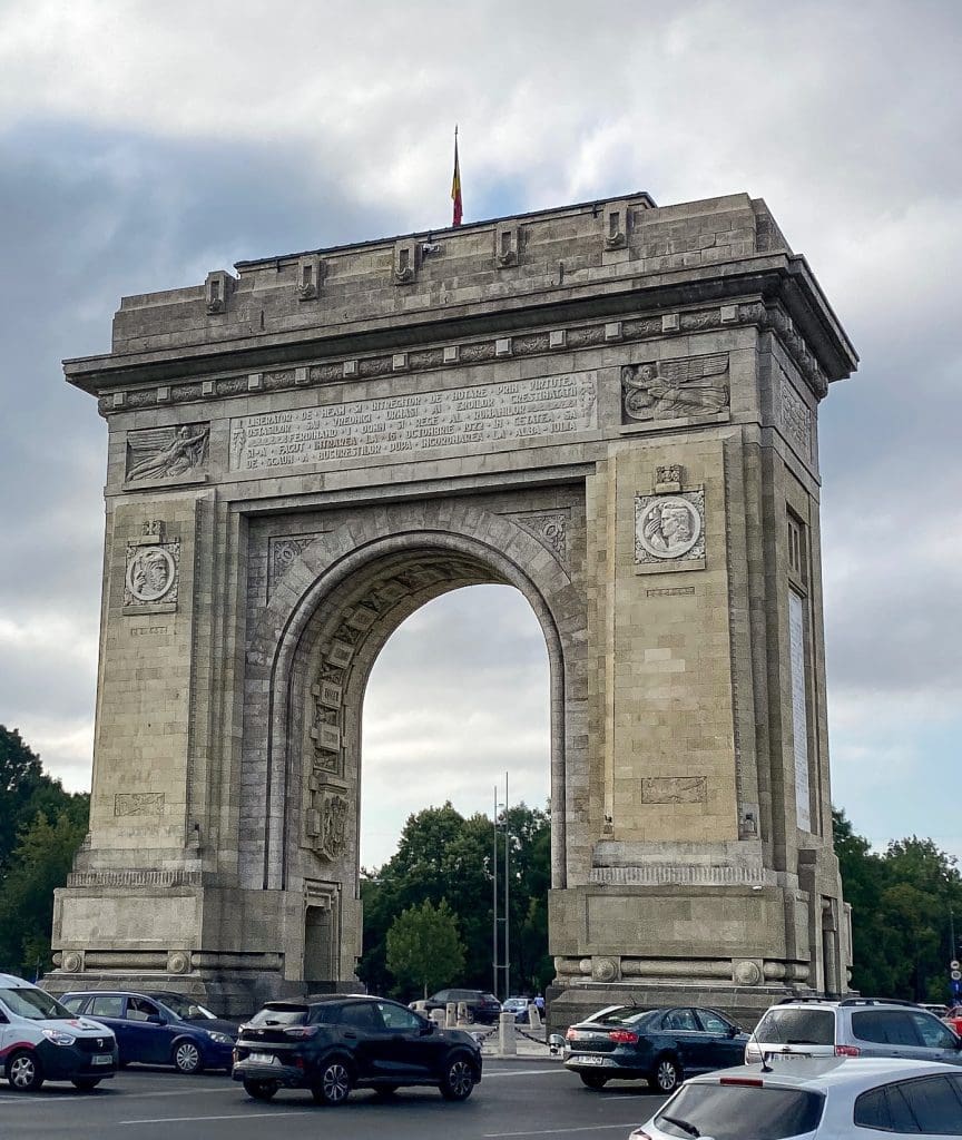 an arch with traffic going around it