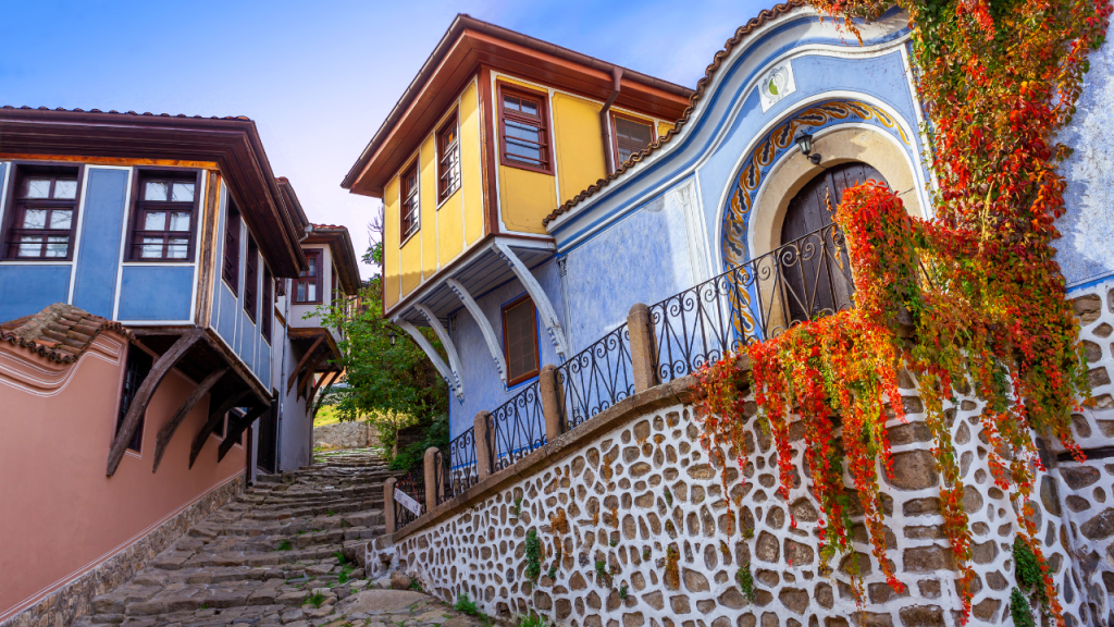 yellow house with rock around bottom