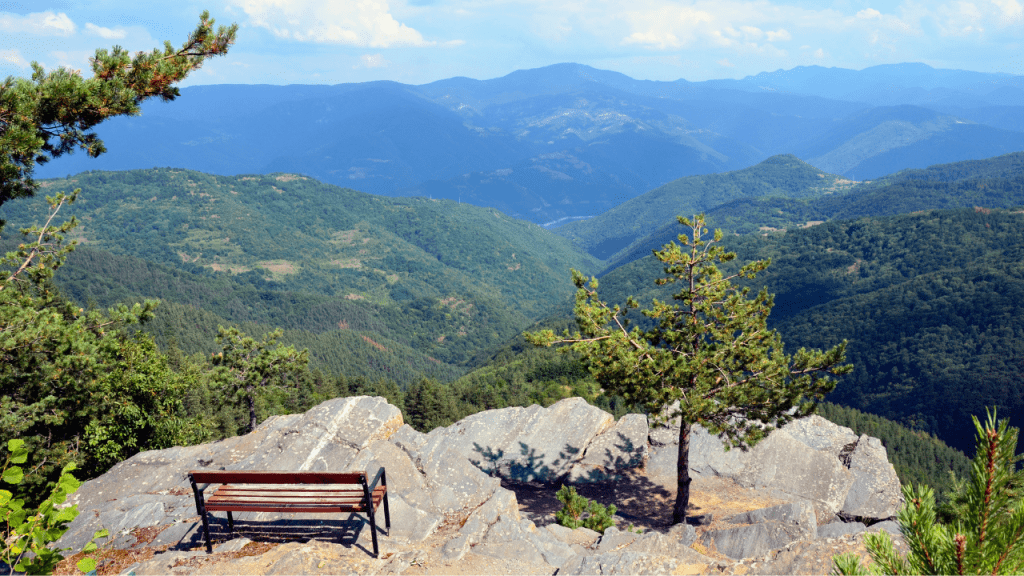 a bench at the top of a mountain
