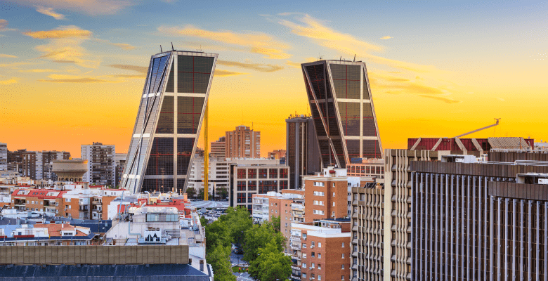a golden sky behind the skyline of Madrid